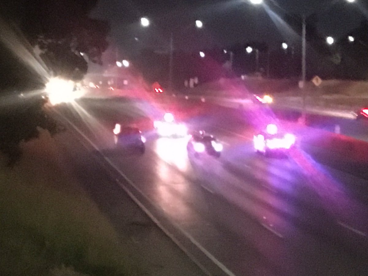 Fatal car-motorcycle accident closes I-75 S at 7 Mile. Michigan State Police investigators on freeway using  flashlights. Skid marks indicate impact was north of 7 mile with car under first turn-around south, and motorcycle further south.