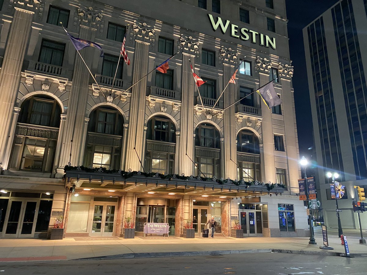 Shooting outside Westin Book-Cadillac Detroit downtown hotel; Four people hospitalized, at least two critical. SUV curbside on Washington Blvd at Michigan Ave about midnight is sprayed with bullets. Another SUV speeds away.